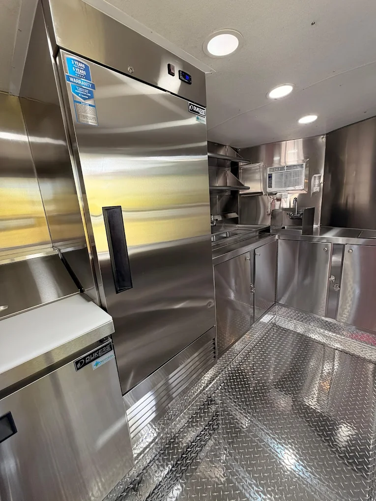 Commercial refrigeration and full kitchen view